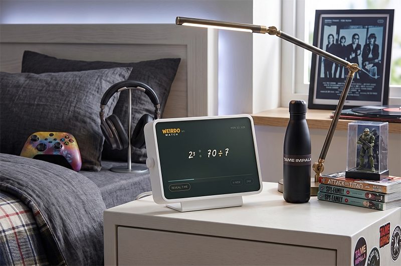 Weirdo Watch Pop, a white-framed clock on a young person's desk